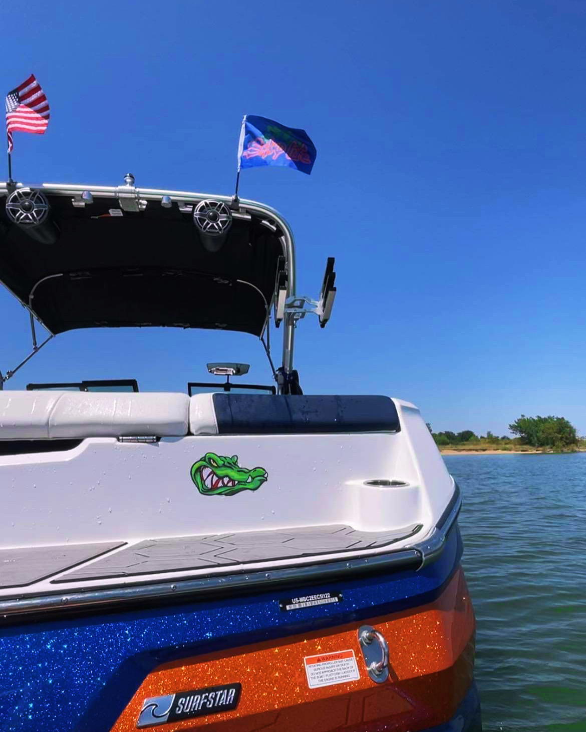 Flags flying from a boat on the water